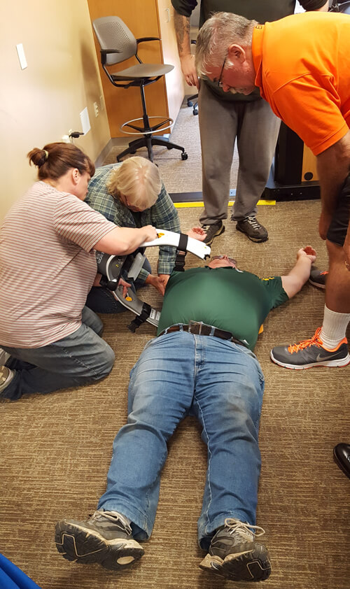Taylor County Ambulance crew members place the LUCAS device on EMT Scott Copenhaver to test out how easy it is to use.