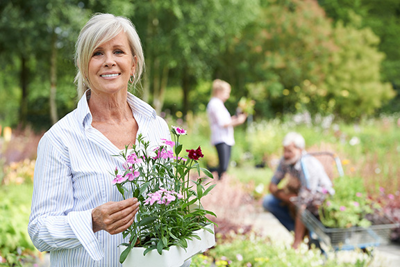 Female smiling and holding flowers